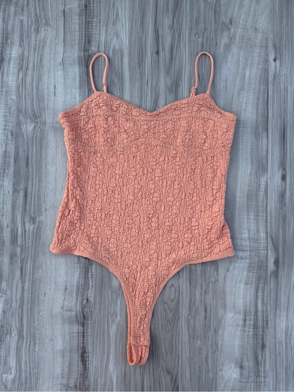 Elodie bodysuit features a distinctive textured lace material